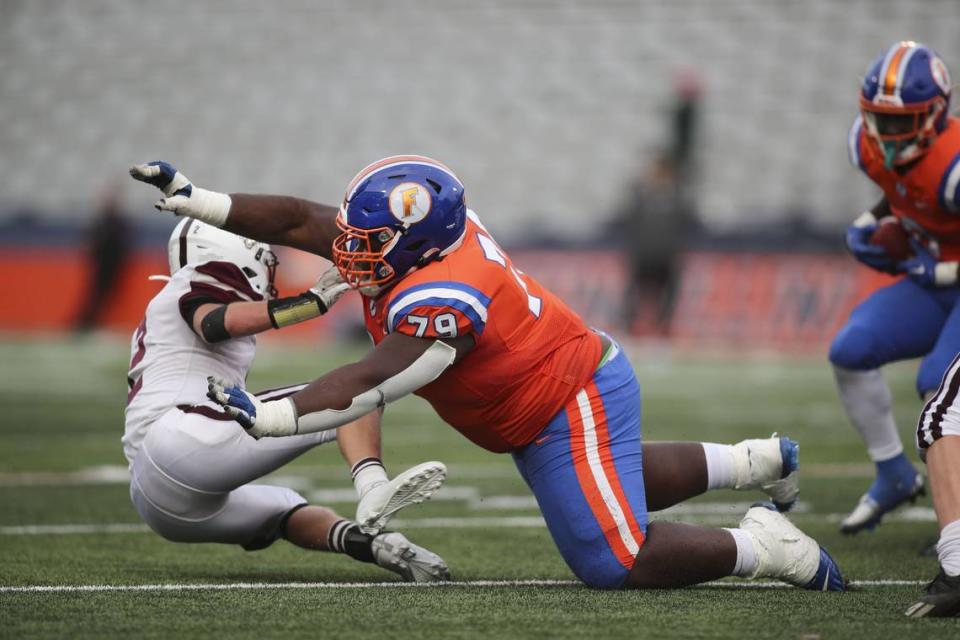 East St. Louis offensive lineman Terran Scarborough levels a Prairie Ridge defender during the IHSA Class 6A state championship game.