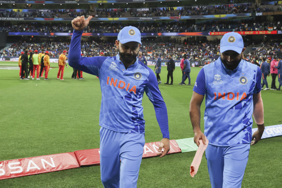 India's Virat Kohli and Rohit Sharma leave the field as they celebrate after defeating Zimbabwe by 71 runs in their T20 World Cup cricket match in Melbourne, Australia, Sunday, Nov. 6, 2022. (AP Photo/Asanka Brendon Ratnayake)
