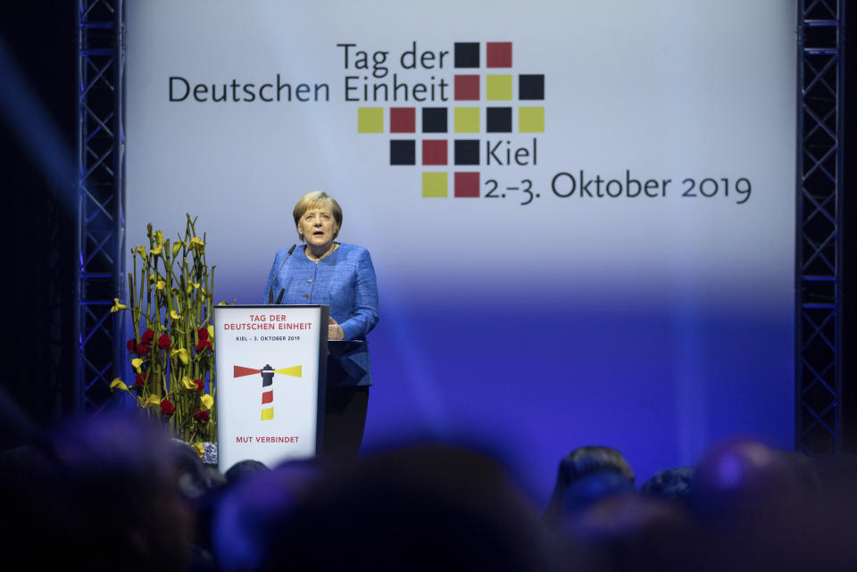 German Chancellor Angela Merkel delivers a speech during a reception to celebrate the German Unification Day in Kiel, Germany, Thursday, Oct. 3, 2019. (Christian Charisius/dpa via AP)