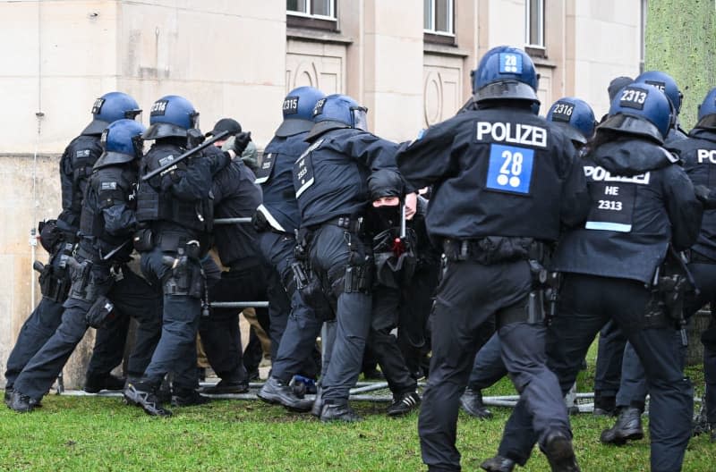 Counter-demonstrators are held back by police on the fringes of a march by right-wing extremists on the occasion of the 79th anniversary of the destruction of Dresden in World War II on 13 February 1945. Robert Michael/dpa