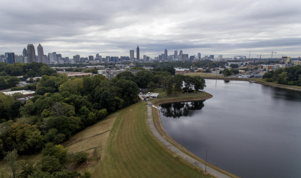 FILE - In this Oct. 15, 2019, file photo, reservoir No. 1, a 180 million-gallon water supply that has been out of service much of the past few decades, sits against the backdrop of the city skyline in Atlanta. U.S. Sen. Kirsten Gillibrand, D-N.Y., is proposing Tuesday, Dec. 17, 2019, to boost federal efforts to fortify the nation's dams following an Associated Press investigation that found scores of potentially troubling dams around the country. (AP Photo/David Goldman, File)