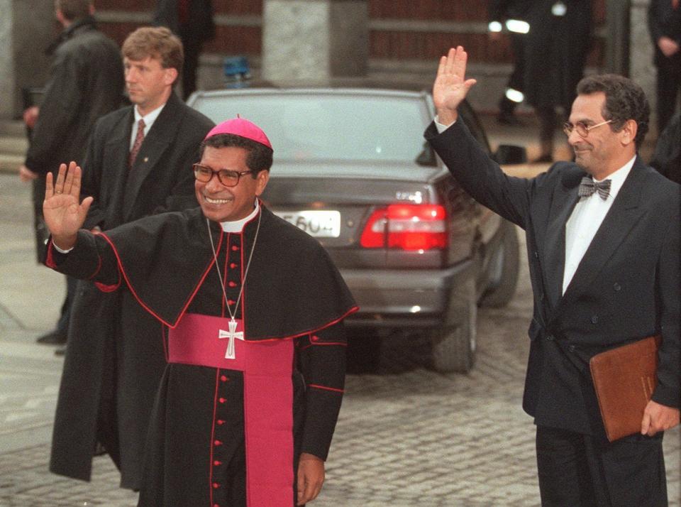 FILE - Nobel Peace Prize laureates East Timor bishop Carlos Filipe Ximenes Belo, left, and activist Jose Ramos-Horta wave upon their arrival at the Oslo townhall for the Nobel ceremony, on Dec. 10, 1996. Belo has been accused in a Dutch magazine article of sexually abusing boys in East Timor in the 1990s, rocking the Catholic Church in the impoverished nation and forcing officials at the Vatican and his religious order to scramble to provide answers. (AP Photo/Jon Eeg, File)