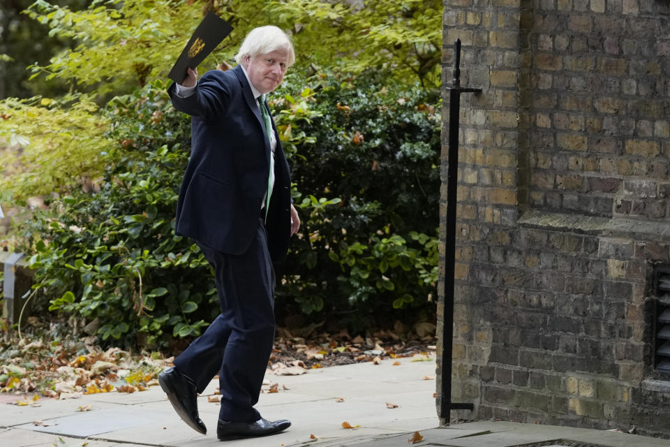 Britain's Prime Minister Boris Johnson waves to reporters on his way to a virtual conference organised by the government of Ukraine and hosted by president Volodymyr Zelensky, in London, Tuesday, Aug. 23, 2022. The Prime Minister will remotely address the international Crimea Platform, a virtual conference.(AP Photo/Frank Augstein)