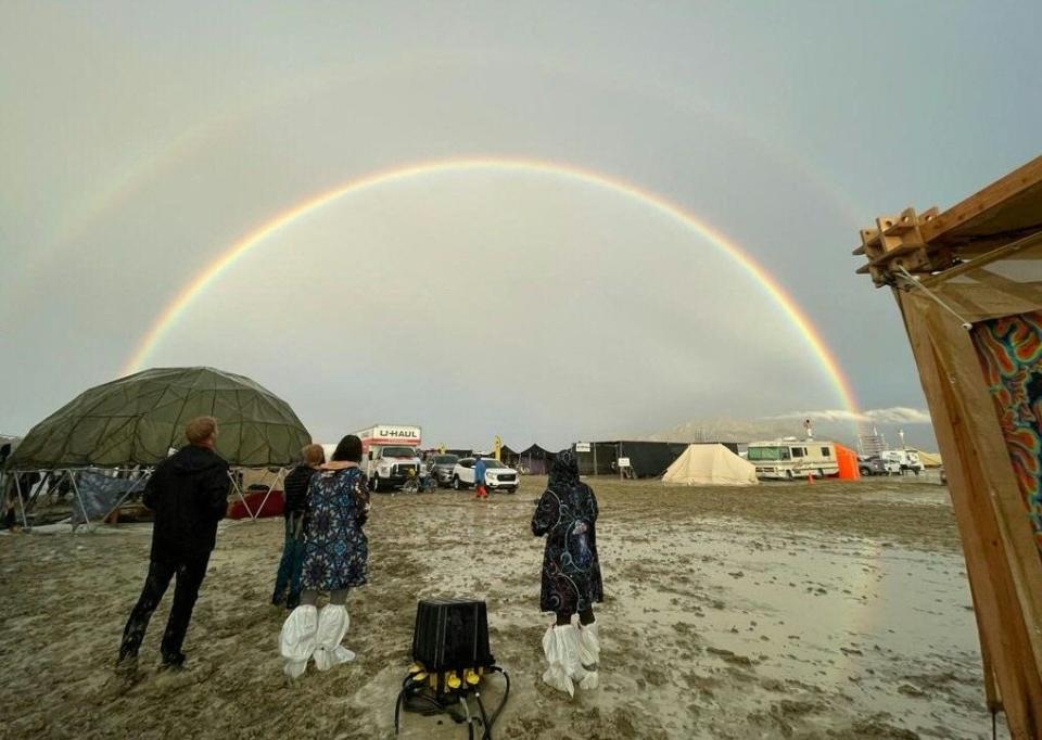 festivalgoers look at a rainbow after heavy rain during burning man festival 2023