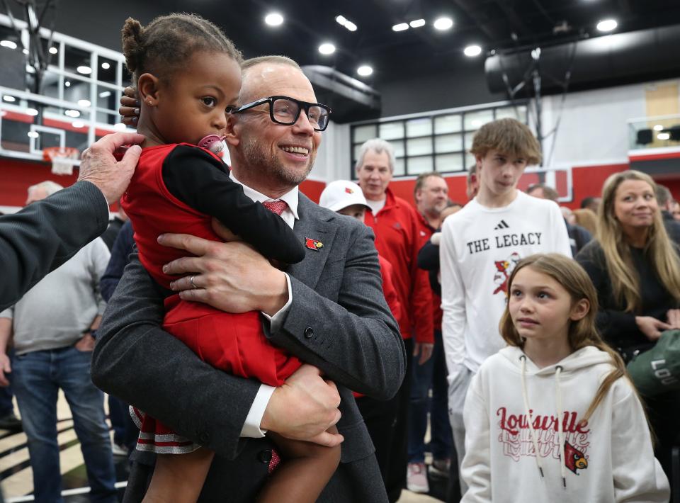Louisville basketball coach Pat Kelsey holds his niece, Teddy, after he was introduced on March 28.