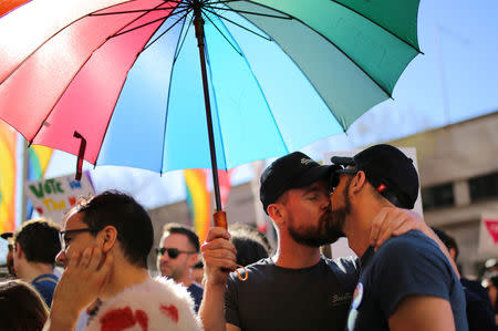 A couple kisses during a march for marriage equality of same-sex couples in Sydney, Australia, September 10, 2017. REUTERS/Steven Saphore