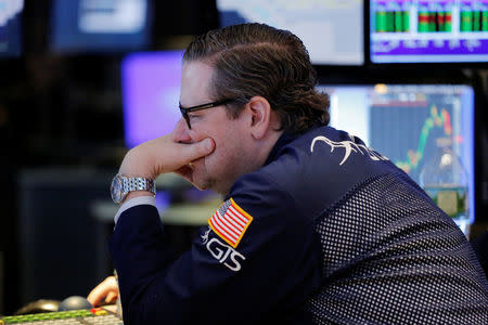 A trader looks at screens while working on the floor of the New York Stock Exchange (NYSE) in New York, U.S., March 27, 2017. REUTERS/Lucas Jackson