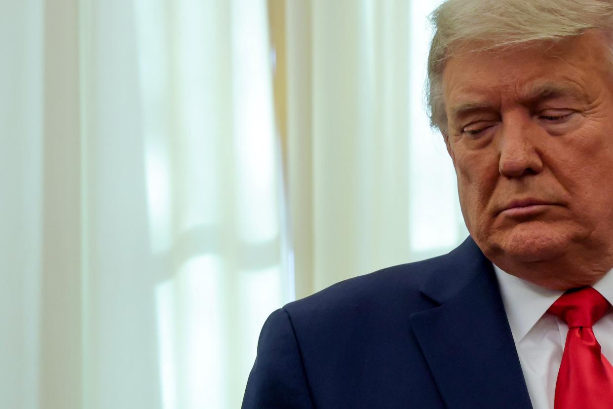 <p>Trump participates in a medal ceremony in the Oval Office at the White House on 3 December.</p> (REUTERS)