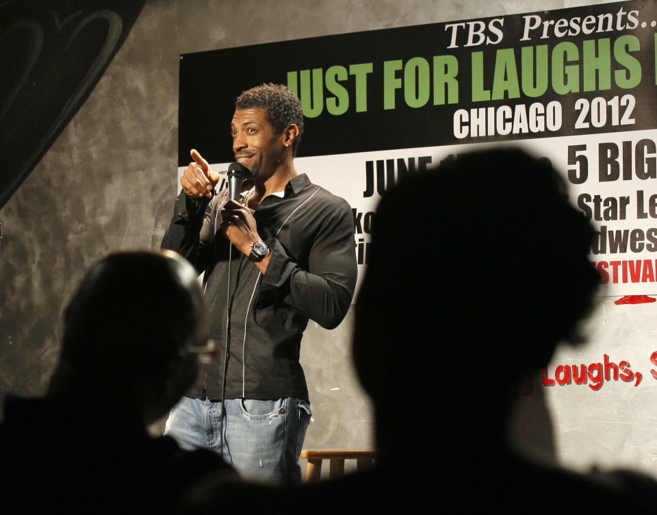 In this June 8, 2012 photo, comedian and writer Deon Cole performs for Jokes and Notes comedy club owner Mary Lindsey during the first of two shows in Chicago's Bronzeville neighborhood. African-American female club owners are a rarity in the industry of comedy, but Lindsey is breaking barriers and uplifting a community by providing a place where raw comedic talent can hone their skills. (AP Photo/Charles Rex Arbogast)