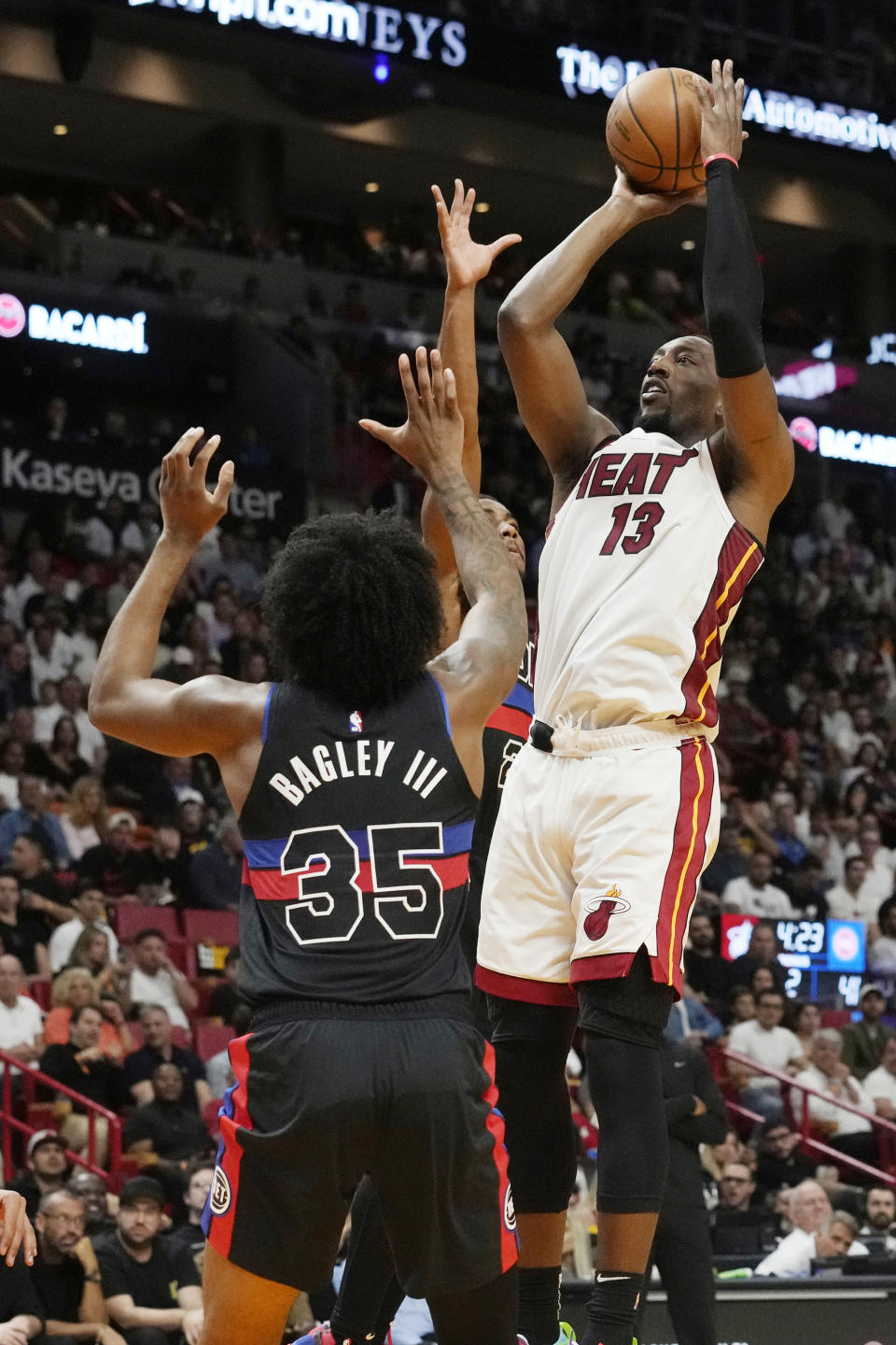 Miami Heat center Bam Adebayo (13) aims to score as Detroit Pistons forward Marvin Bagley III (35) defends during the first half of an NBA basketball game, Wednesday, Oct. 25, 2023, in Miami. (AP Photo/Marta Lavandier)