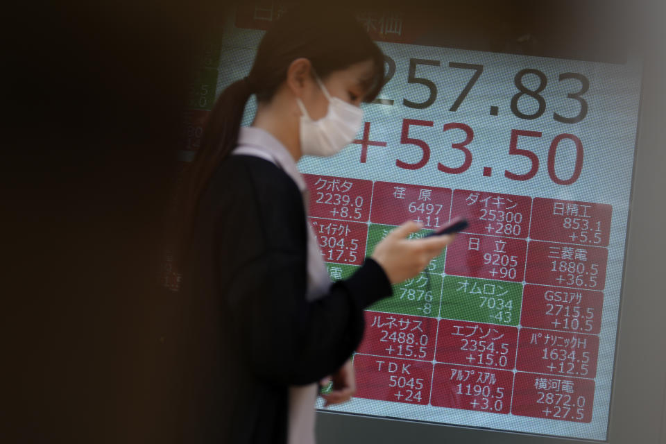 A person walks in front of an electronic stock board showing Japan's Nikkei 225 index at a securities firm Thursday, Aug. 10, 2023, in Tokyo. Asian benchmarks mostly fell Thursday after shares declined on Wall Street and investors braced for a highly anticipated report on U.S. inflation. (AP Photo/Eugene Hoshiko)