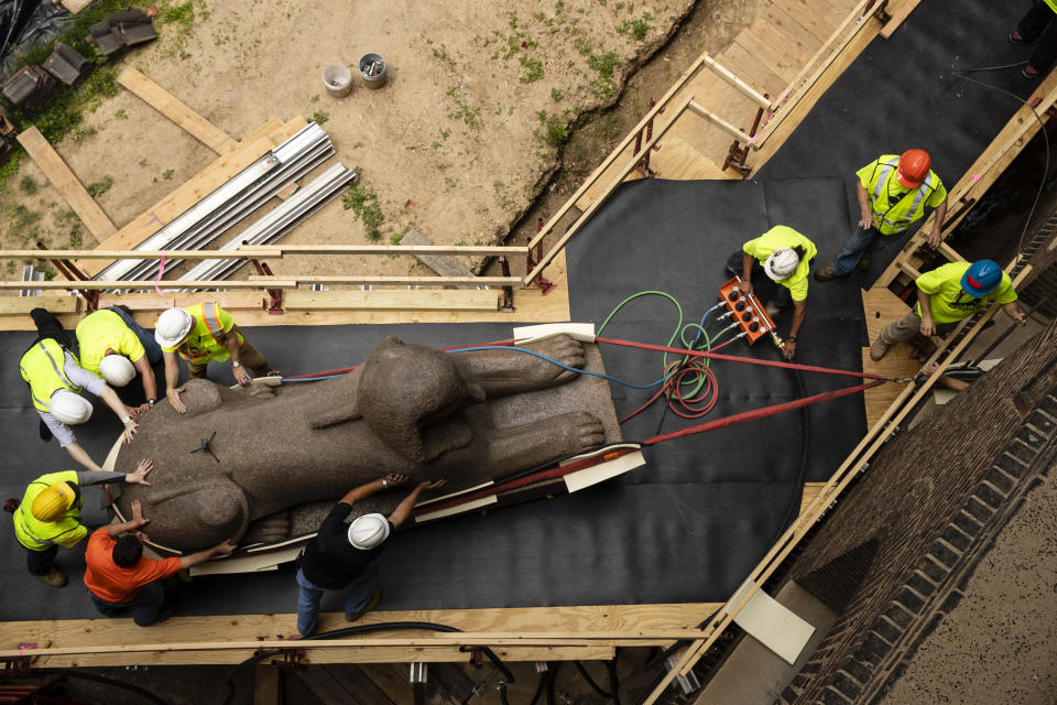 Workers move a 25,000-pound Sphinx of Ramses II at the Penn Museum in Philadelphia, Wednesday, June 12, 2019. The 3,000-year-old sphinx is being relocated from the Egypt Gallery where it's resided since 1926 to a featured location in the museum's new entrance hall. (AP Photo/Matt Rourke)