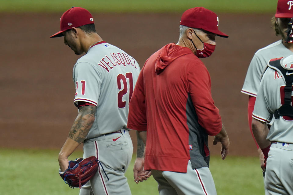 Philadelphia Phillies manager Joe Girardi takes starting pitcher Vince Velasquez (21) out of the game against the Tampa Bay Rays during the fifth inning of a baseball game Friday, Sept. 25, 2020, in St. Petersburg, Fla. (AP Photo/Chris O'Meara)