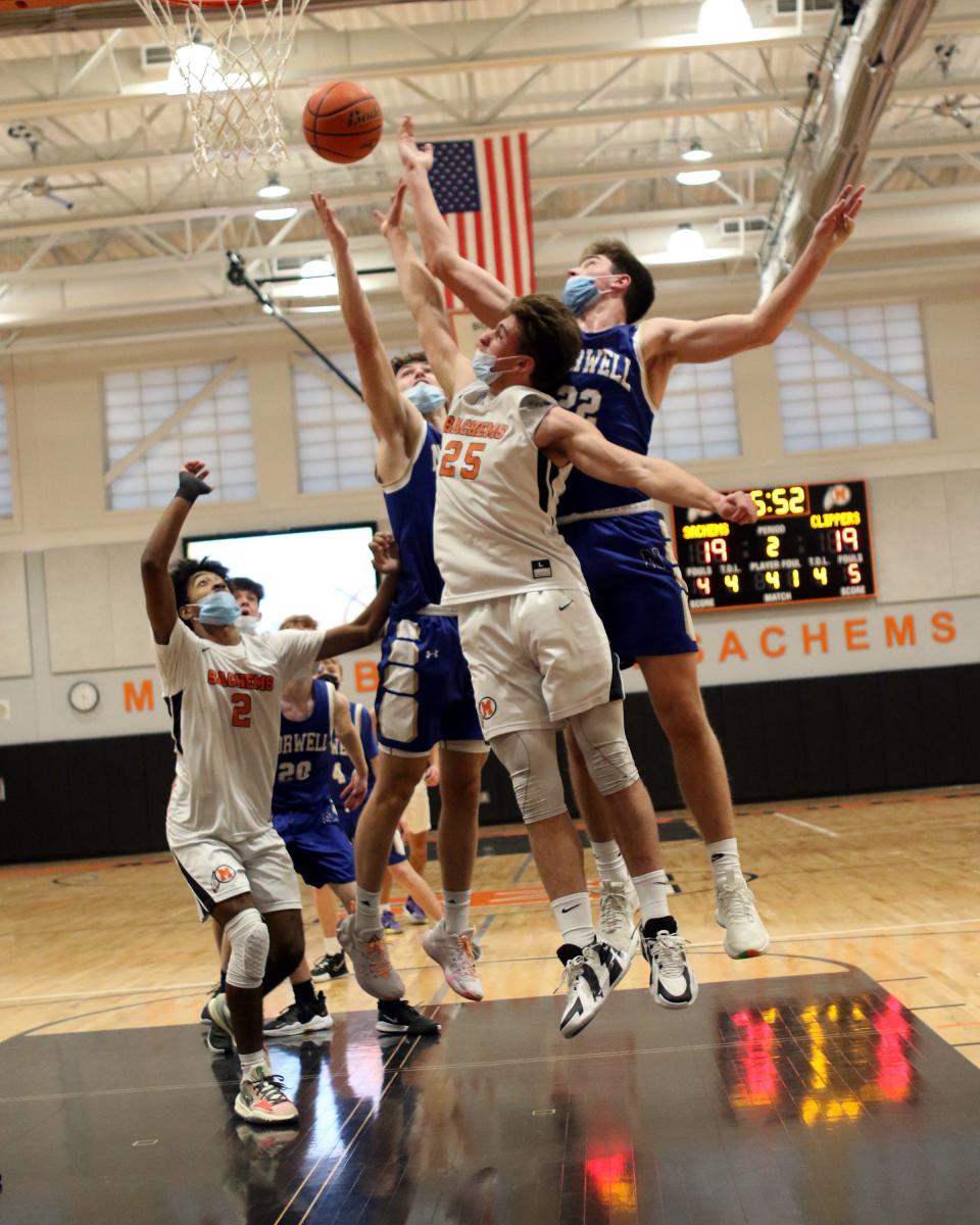 Cam Downey battles for the rebound as Isaiah Furtado waits for any deflections.