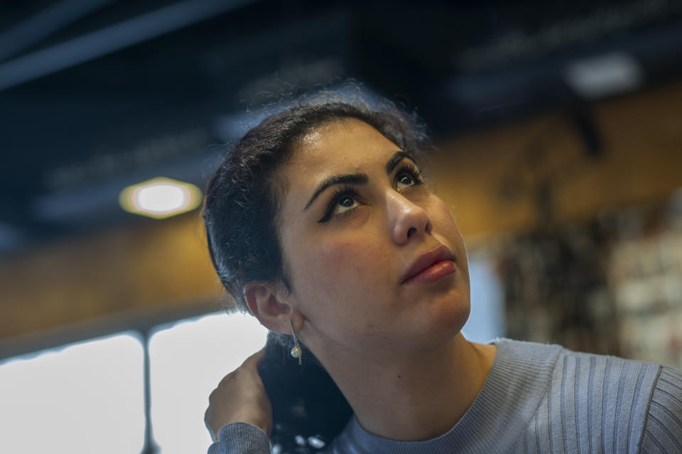 Noor Alhuda Saad, 26, a Ph.D. candidate at Mustansiriya University who describes herself as a political activist, sits in a Baghdad cafe on Wednesday, March 1, 2023. She says her generation has been leading protests decrying corruption, demanding services and seeking more inclusive elections -- and won’t stop till they’ve built a better Iraq. “The people in power do not see these as important issues for them to solve. And that is why we are active.” (AP Photo/Jerome Delay)
