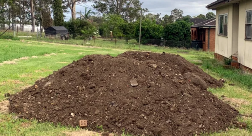 Large mountains of illegal construction waste dumped into a Sydney resident's yard. 