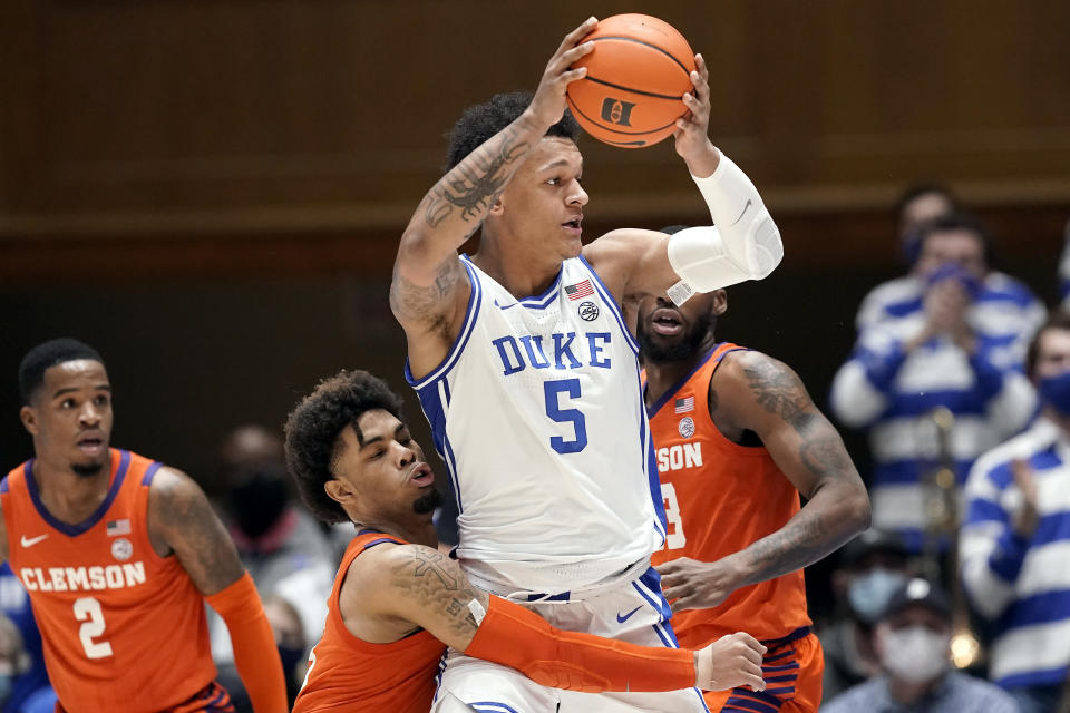 Duke forward Paolo Banchero (5) looks to pass while Clemson guard David Collins defends during the first half of an NCAA college basketball game in Durham, N.C., Tuesday, Jan. 25, 2022. (AP Photo/Gerry Broome)
