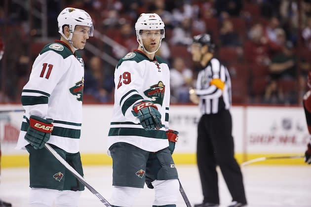 Minnesota Wild’s Jason Pominville (29) talks with Zach Parise (11) during the second period of an NHL hockey game against the Arizona Coyotes Friday, Dec. 11, 2015 in Glendale, Ariz. The Coyotes defeated the Wild in overtime 2-1. (AP Photo/Ross D. Franklin)