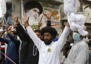 Supporters of Tehreek-e-Labiak Pakistan, a radical Islamist political party, chant slogans during a sit-in protest against the arrest of their party leader Saad Rizvi and demanding to expel the French envoy from the country, in Lahore, Pakistan, Friday, April 16, 2021. Pakistan briefly blocked access to all social media on Friday, after days of anti-French protests across the country by radical Islamists opposed to cartoons they consider blasphemous. (AP Photo/K.M. Chaudary)