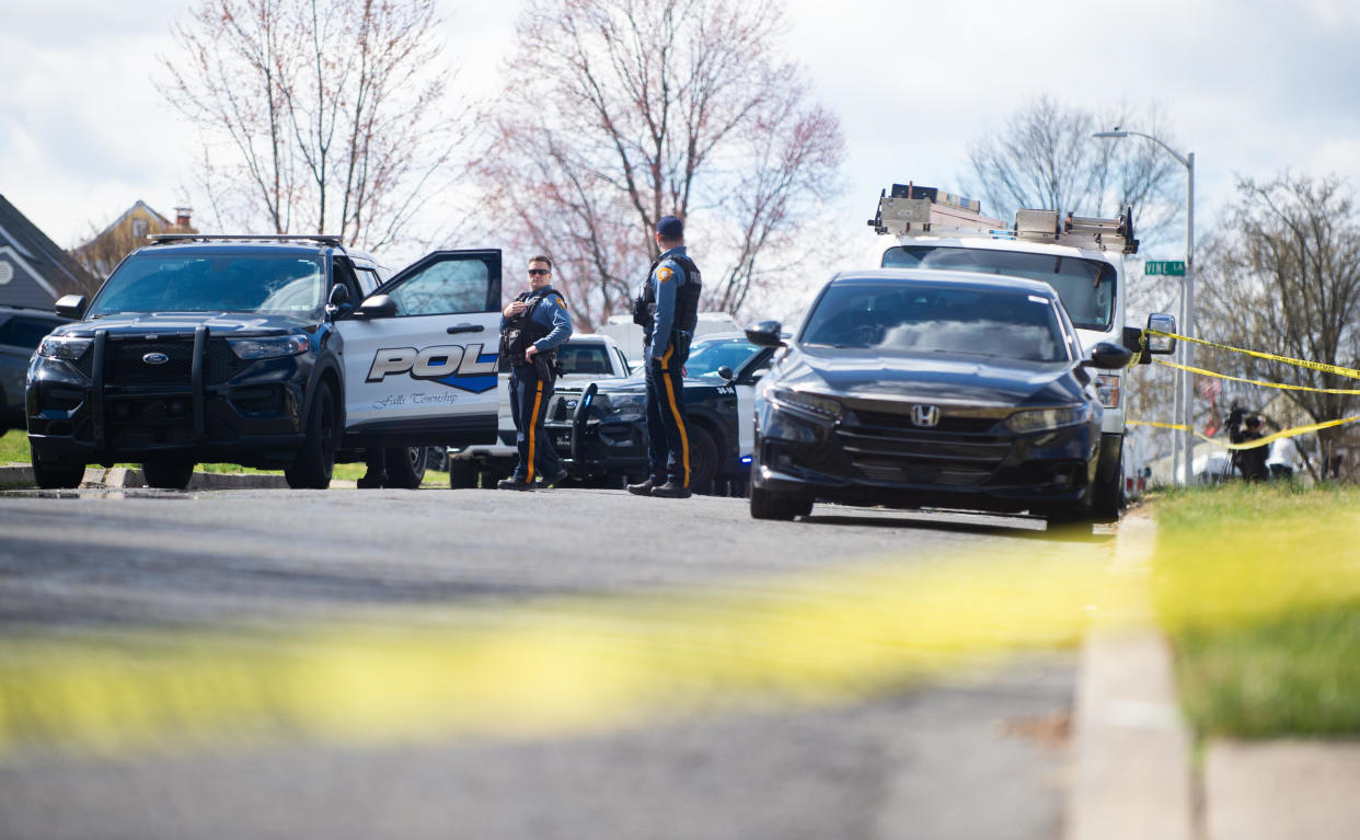 LEVITTOWN, PENNSYLVANIA - Police officers from the Falls Township Police Department tape off and inspect the scene of one of three shootings in the Vermillion Hills neighborhood on March 16, 2024. / Credit: / Getty Images