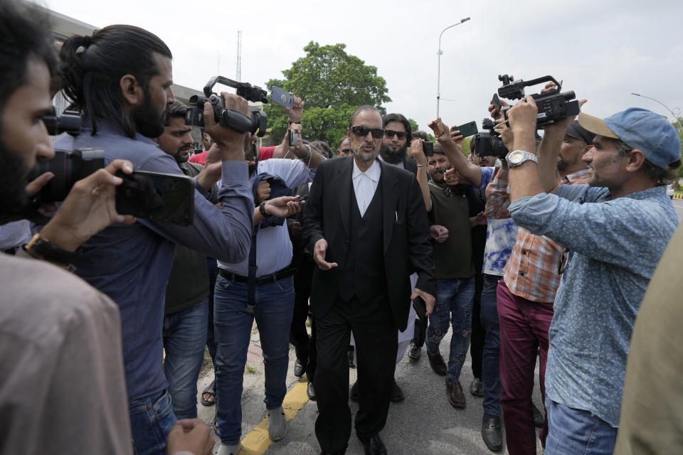 Babar Awan, center, a leading lawyer of imprisoned former Prime Minister Imran Khan's legal team, talks to media as he leaves the Islamabad High Court in Islamabad, Pakistan, Thursday, Aug. 24, 2023. A court in Pakistan's capital is likely to issue a crucial ruling Thursday on an appeal from the country's imprisoned former Prime Minister Khan against his recent conviction and three-year sentence in a graft case, one of his lawyers said. (AP Photo/Anjum Naveed)