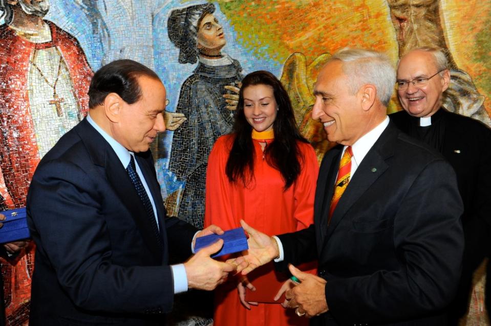 During a reception at the St. John’s chapel following Eleonora’s graduation, Silvio Berlusconi (left) handed a smiling Sciame a blue box with an Italian paperweight as a memento. Photo courtesy of St. John's University