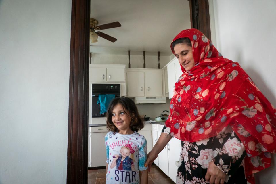 Roqia Azizyar with her daughter, Zainab, who is about to begin second grade. The kids have learned some English in school and made some friends in the neighborhood.