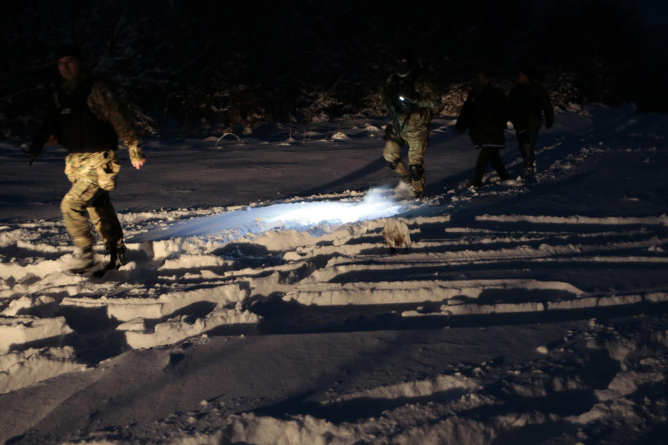 Bosnian police return from chasing a suspected serial killer in the village of Medvjedice 30 kms south of Sarajevo, Bosnia, Tuesday, Feb. 12, 2019. Bosnia police on Tuesday shot and killed the country's most-wanted fugitive, who had been sought in the slayings of a police officer and another person, after a huge manhunt. Edin Gacic died after a shootout with police near the capital Sarajevo, police said. (AP Photo/Amel Emric)