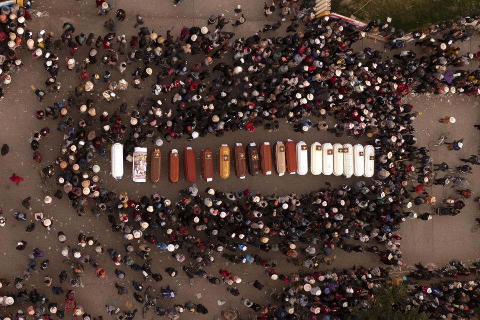 FILE - Residents surround coffins during a vigil for the more than a dozen people who died during the unrest in Juliaca, Peru, Tuesday, Jan. 10, 2023. Human rights groups, including the United Nations, have called on the Peruvian government to investigate claims of excessive force used by police and soldiers during recent protests that have left 49 civilians dead, and the autopsies provide some evidence of the alleged use of lethal ammunition. (AP Photo/Jose Sotomayor, File)