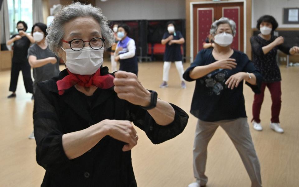 Women wattend a dance class re-opened for the first time since the start of the pandemic at Seodaemun Senior Welfare Centre in Seoul  - AFP