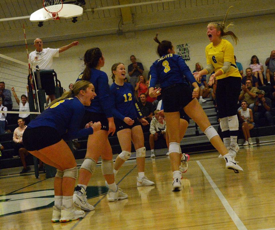 Clear Spring libero Emerson Moats (6) leaps for joy and celebrates with her teammates, including Lizzie Lawson, left, and Emilee Hixon (12), during Tuesday's Washington County volleyball match against South Hagerstown.