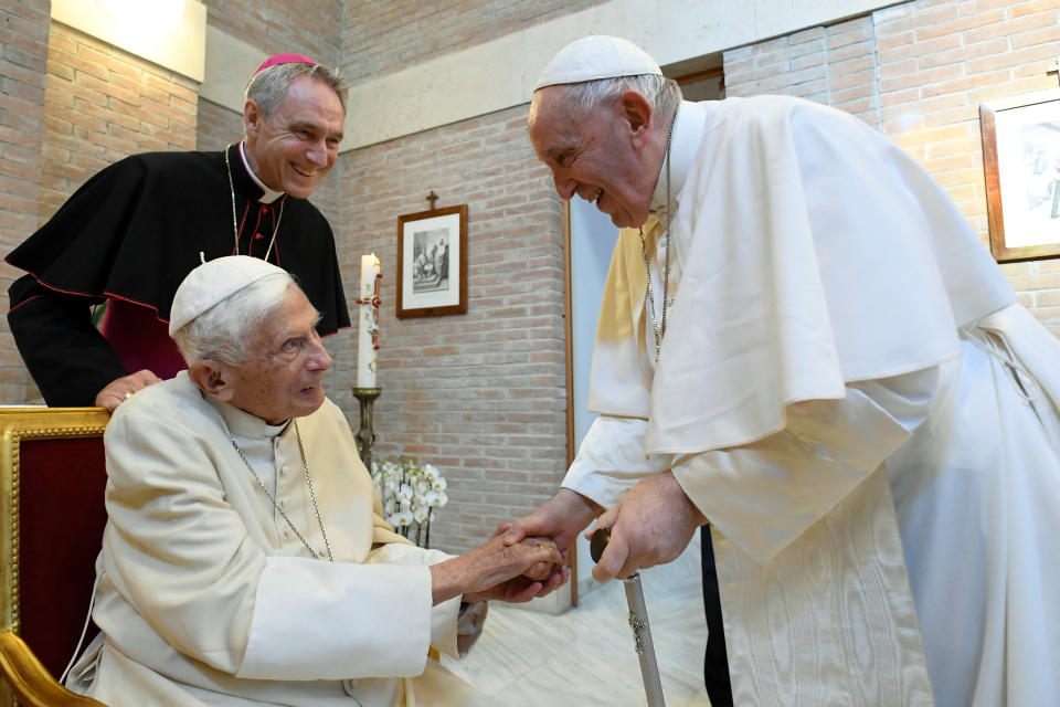 Pope Francis and Pope Emeritus Benedict XVI attend a meeting on the day of a consistory ceremony to elevate Roman Catholic prelates to the rank of cardinal, at the Vatican August 27, 2022. Vatican Media/Handout via REUTERS ATTENTION EDITORS - THIS PICTURE HAS BEEN PROVIDED BY A THIRD PARTY.