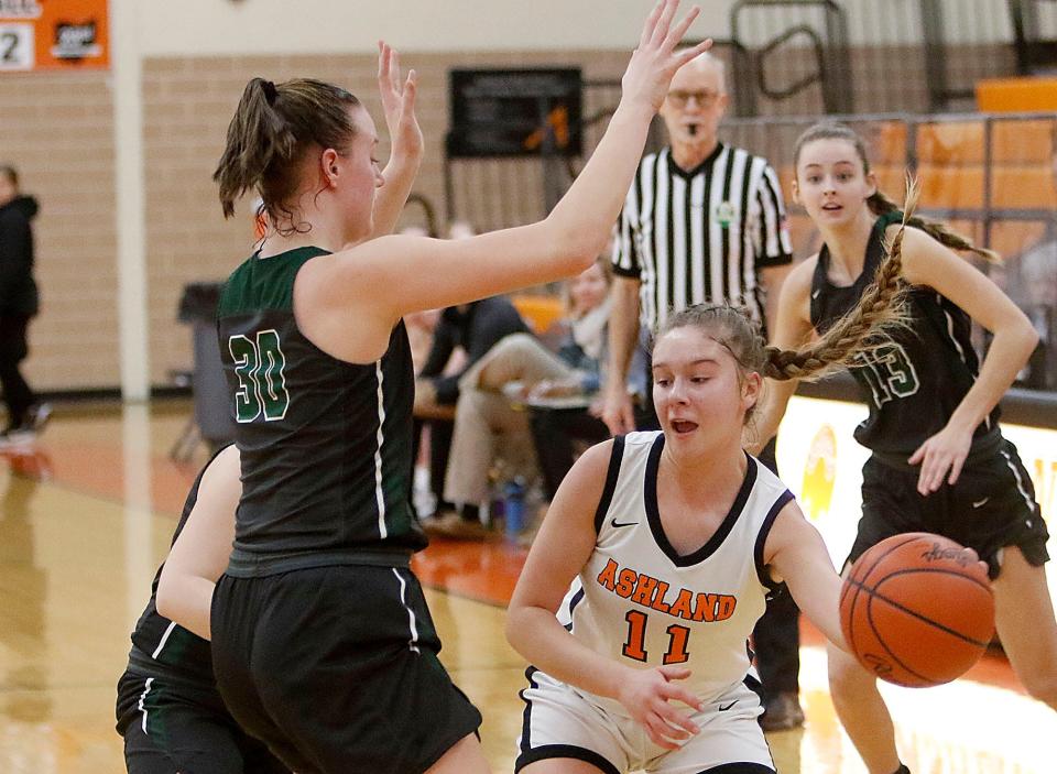 Ashland High School's Klaira Paramore (11) passes the ball as Madison High School's Faith Kuhn (30) defends during high school girls basketball action Thursday, Jan. 20, 2022. TOM E. PUSKAR/TIMES-GAZETTE.COM