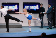 LOS ANGELES, CA - JUNE 05: Xavier Poix (2nd R), managing director of Ubisoft French Studios, demonstrates with Nintendo of America President and COO Reggie Fils-Aime (R) Ubisoft's "Just Dance 4" multiperson dancing and signing game for Wii U during a press conference for Nintendo's new hand held game console Wii U at the Electronic Entertainment Expo at the Galen Center on June 5, 2012 in Los Angeles, California. Thousands are expected to attend the annual three-day convention to see the latest games and announcements from the gaming industry. (Photo by Kevork Djansezian/Getty Images)