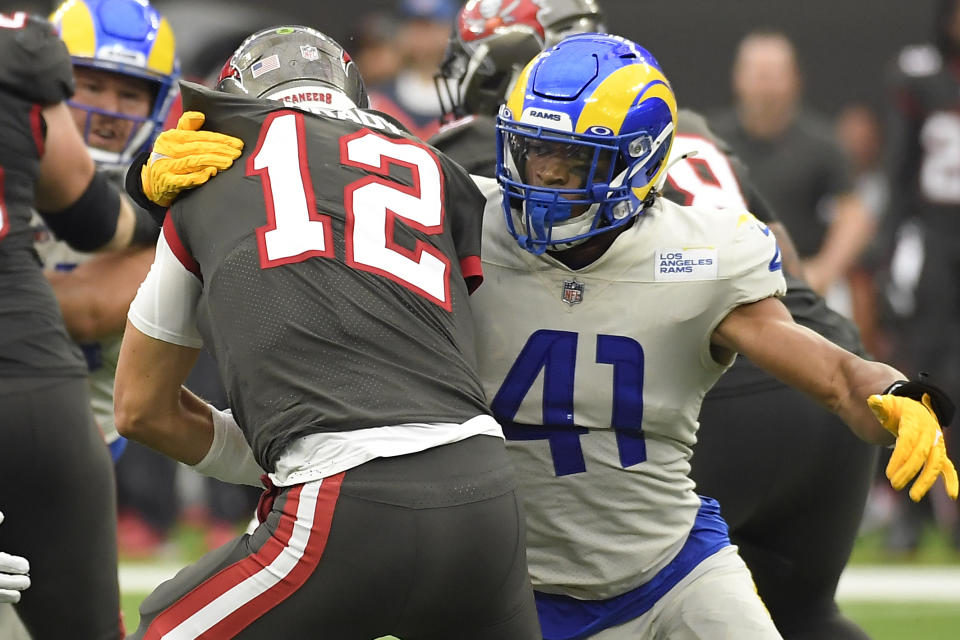 FILE - Los Angeles Rams inside linebacker Kenny Young, right, sacks Tampa Bay Buccaneers quarterback Tom Brady (12) during the second half of an NFL football game in Inglewood, Calif., in this Sunday, Sept. 26, 2021, file photo. The injury-riddled Denver Broncos acquired inside linebacker Kenny Young from the Los Angeles Rams on Monday, Oct. 25, 2021, four days after they were gouged by third-string Cleveland running back De'Ernest Johnson. (AP Photo/Kevork Djansezian, File)