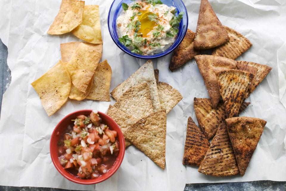 In this image taken on June 10, 2013, from left, fried tortilla chips with cinnamon sugar, baked whole wheat tortilla chips, and baked whole wheat pita chips are shown in Concord, N.H. (AP Photo/Matthew Mead)