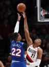 Sacramento Kings center Richaun Holmes, left, shoots over Portland Trail Blazers center Hassan Whiteside during the first half of an NBA basketball game in Portland, Ore., Saturday, March 7, 2020. (AP Photo/Steve Dipaola)