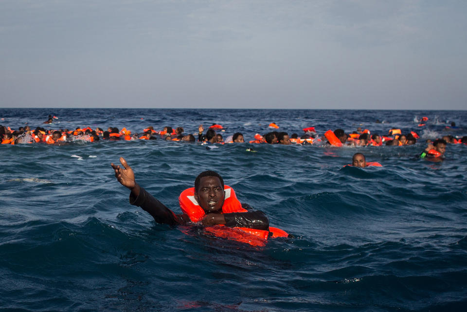 <p>Refugees and migrants are seen swimming and yelling for assistance from crew members from the Migrant Offshore Aid Station (MOAS) ‘Phoenix’ vessel after a wooden boat bound for Italy carrying more than 500 people capsized on May 24, 2017 off Lampedusa, Italy. Photo: Chris McGrath/Getty Images) </p>