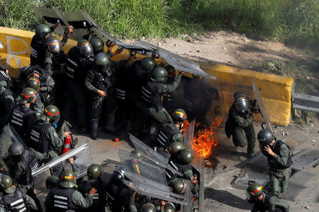 Riot security forces catch fire during a march to the state Ombudsman's office in Caracas, Venezuela May 29, 2017. REUTERS/Carlos Garcia Rawlins
