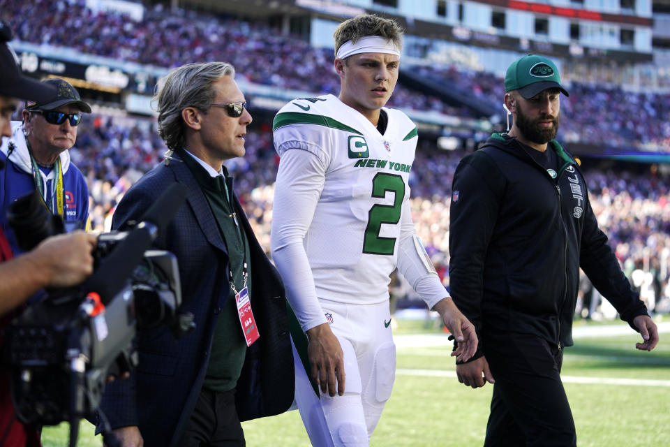 New York Jets quarterback Zach Wilson (2) is escorted to the locker room after an apparent injury during the first half of an NFL football game against the New England Patriots, Sunday, Oct. 24, 2021, in Foxborough, Mass. (AP Photo/Steven Senne)