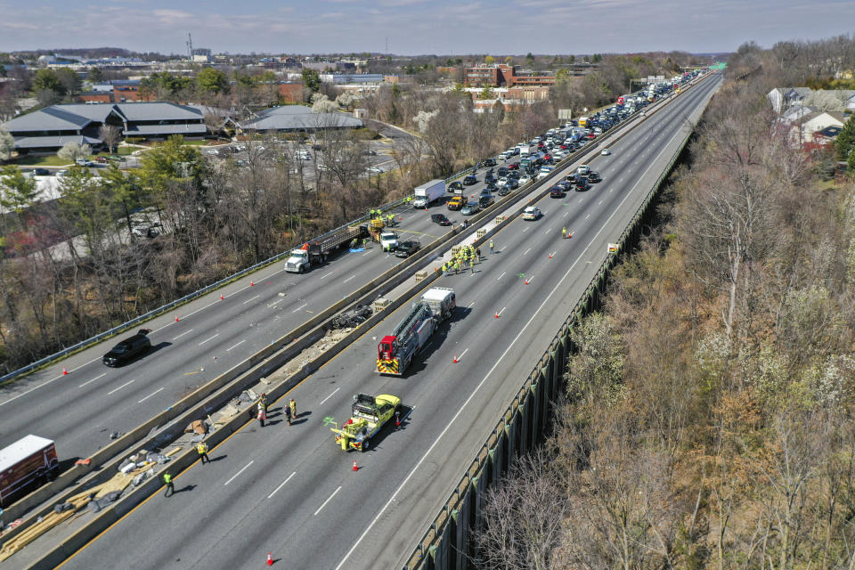 Emergency personnel work at the scene of fatal crash along Interstate 695 near Woodlawn, Md., Wednesday, March 22, 2023. At least six people were dead after a crash that closed the Baltimore Beltway in both directions Wednesday, snarling traffic along the west side of the highway that encircles the city, Maryland State Police said. (Jerry Jackson/The Baltimore Sun via AP)