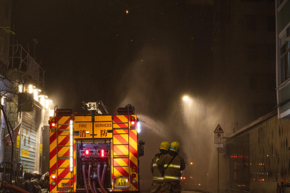 Firefighters battle a fire at a construction site in Hong Kong, Friday, March 3, 2023. Hong Kong firefighters are battling the blaze that broke out at a construction site in the city's popular shopping district. (AP Photo/Louise Delmotte)