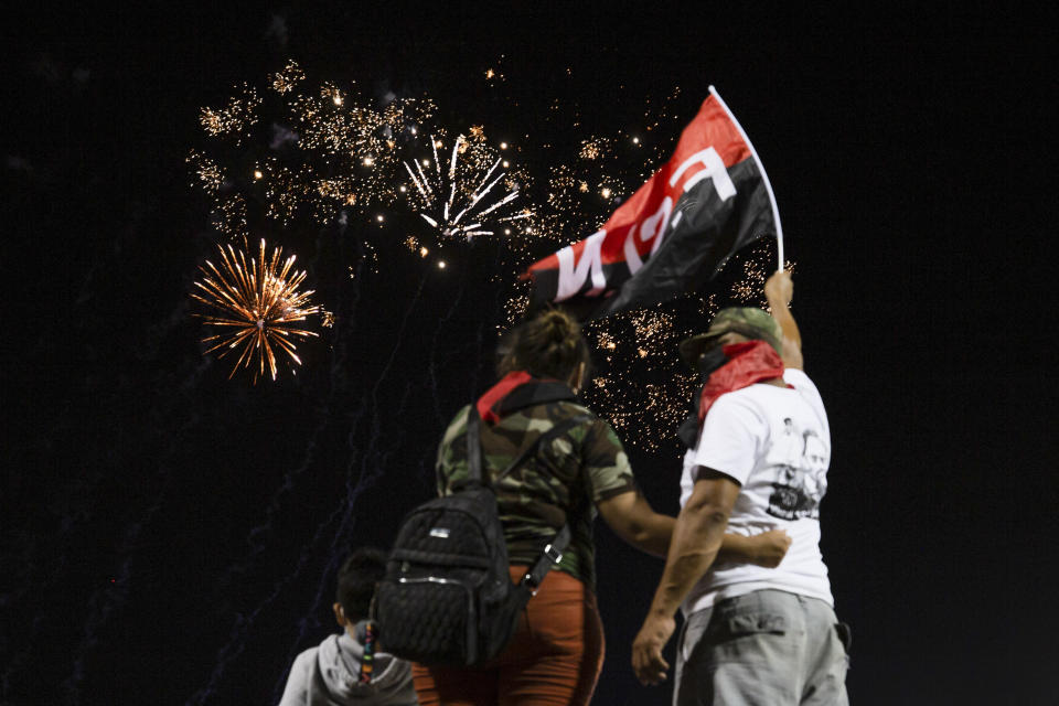 Supporters of the Sandinista National Liberation Front (FSLN) watch fireworks during commemorations for the 42nd anniversary of the triumph of the 1979 Sandinista Revolution that toppled dictator Anastasio Somoza in Managua, Nicaragua, early Monday, July 19, 2021. (AP Photo/Miguel Andrés)