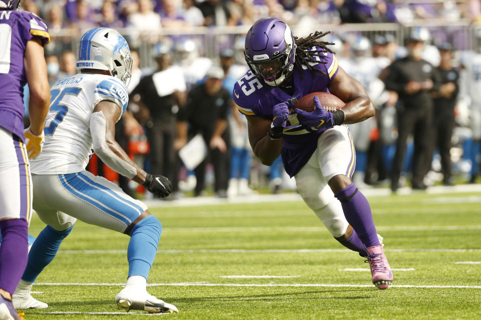 Minnesota Vikings running back Alexander Mattison runs from Detroit Lions safety Will Harris, left, during a 15-yard touchdown reception during the first half of an NFL football game, Sunday, Oct. 10, 2021, in Minneapolis. (AP Photo/Bruce Kluckhohn)