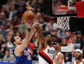 Sacramento Kings forward Nemanja Bjelica, left, shoots as Portland Trail Blazers center Hassan Whiteside defends during the first half of an NBA basketball game in Portland, Ore., Saturday, March 7, 2020. (AP Photo/Steve Dipaola)