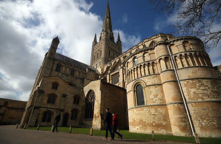 People walk past Norwich Cathedral in Norwich, Britain, March 20, 2018. REUTERS/Hannah McKay/Files