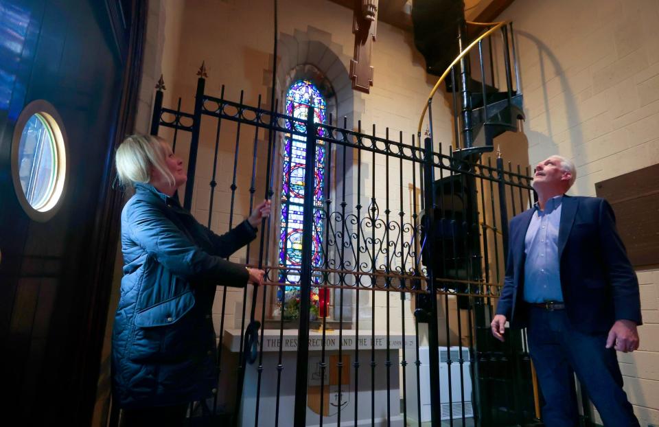 Lisa Baker, the chairman of trustees at the Mariners' Church of Detroit, and Ken Morse, a trustee, look up as Baker rings the bell at the church on Jefferson Avenue in downtown Detroit on Tuesday, May 2, 2023.
