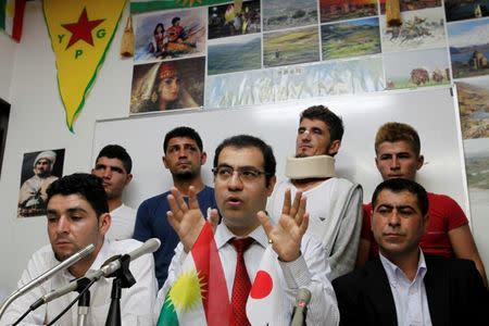 The leader of the Japan Kurdish Cultural Association Vakkas Colak (C) speaks at a news conference in a northern Tokyo suburb three days after violence between Kurdish and Turkish men, October 28, 2015. REUTERS/Thomas Wilson