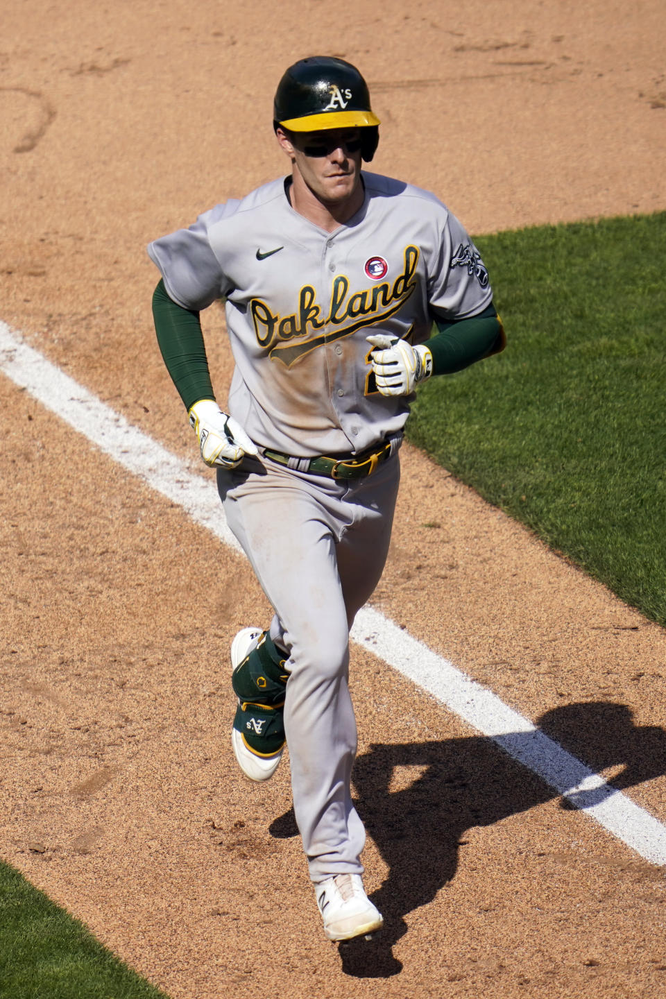 Oakland Athletics' Mark Canha (20) jogs home on a solo home run off Minnesota Twins pitcher Jose Berrios in the fifth inning of a baseball game, Saturday, May 15, 2021, in Minneapolis. (AP Photo/Jim Mone)