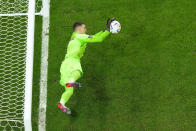 Croatia's goalkeeper Dominik Livakovic saves a shot during a penalty shootout during the World Cup quarterfinal soccer match between Croatia and Brazil, at the Education City Stadium in Al Rayyan, Qatar, Friday, Dec. 9, 2022. (AP Photo/Petr David Josek)